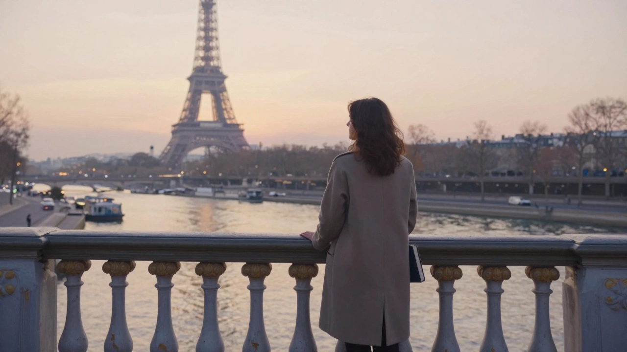 A woman stands alone on a bridge at sunrise, gazing at the Eiffel Tower with quiet reflection.